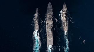 JS Oumi (centre) conducts a dual Replenishment at Sea with HMAS Arunta (left) and USS Milius during Exercise Malabar 2022