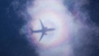 An Australian P-8A Poseidon leaves a shadow on the clouds above the Indian Ocean